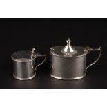 Two Victorian silver mustard pots with blue glass liners
one of oval form, hallmarked London 1900,