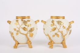 A large pair of Victorian Royal Worcester ovoid cream and gilt vasesthe basket weave bodies mounted