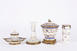 A late 19th century Continental porcelain desk setcomprising an inkwell, a candlestick and a