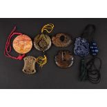 Six various 20th century Chinese carved hardstone pendants including a hollowed and pierced roundel,