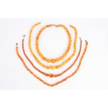 Three natural Baltic butterscotch amber necklaces, two of oval, polished and graduated beads, one of