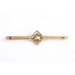 A gold and diamond bar brooch
set with central diamond weighing approx. 0.60cts, in a square mount