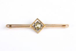 A gold and diamond bar broochset with central diamond weighing approx. 0.60cts, in a square mount
