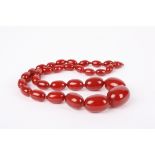 A graduated cherry amber coloured bead necklace
with gilt metal clasp., 24.6 grams.Condition: Good