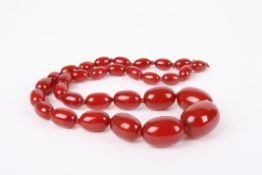 A graduated cherry amber coloured bead necklacewith gilt metal clasp., 24.6 grams.Condition: Good