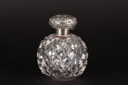 An early 20th century silver topped cut glass scent bottlewith embossed silver lid with