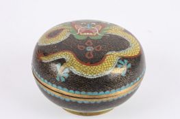 An early 20th century Japanese cloisonné powder bowl and coverdecorated with a dragon on a black