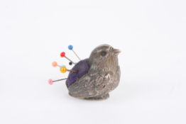 A novelty silver pin cushion in the form of a birdrealistically modelled and hallmarked Chester
