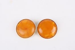 A pair of 9ct gold mounted butterscotch amber coloured earringsthe amber roundels set in 9ct gold