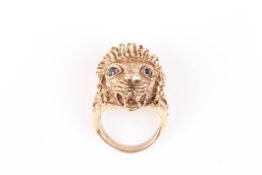 A heavy 9ct gold lions head ringwell modelled with mouth open and sapphire eyes., Approx 26.8 grams
