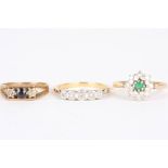 A group of three diamond rings
comprising an emerald and diamond daisy cluster ring set in 18ct