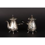 A pair of Edwardian embossed silver chocolate pots
hallmarked Birmingham 1909, with floral
