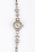 An Art Deco diamond set ladies cocktail wristwatchthe circular dial surrounded by a diamond border,