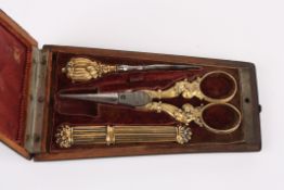 An 18th century French etuicontaining sewing accessories with gold coloured handles including