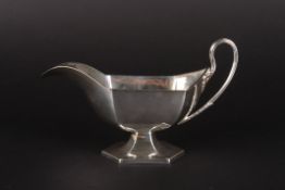 An Edwardian silver hexagonal sauce boathallmarked Sheffield 1910, with scrolled handle and