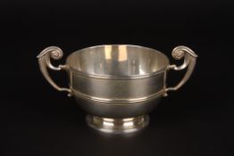 An Edwardian silver two handled sugar bowlhallmarked Sheffield 1903, with twin scrolled handles and