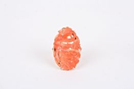 A Chinese carved coral and gold ringset with a carved coral plaque of flowers, mounted in an