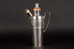 A 1930s silver plated cocktail shakerwith banded body and scrolled handle., 28.5 cm high.Condition: