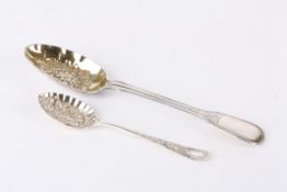 Two berry spoonsthe first larger spoon silver and hallmarked London 1864 the gilded bowl with fruit