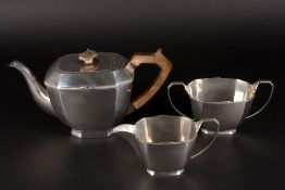 A George V silver three piece tea sethallmarked Sheffield 1935 and 1936, comprising teapot, milk