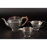 A George V silver three piece tea set
hallmarked Sheffield 1935 and 1936, comprising teapot, milk