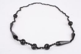 An early 20th century carved jet necklacewith facetted and carved beads., Condition: Generally good