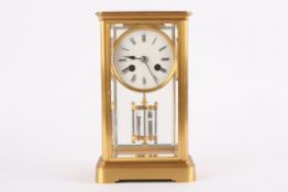 A Victorian gilt bronze four glass mantle clock of small proportionsthe white enamel dial with