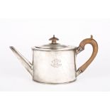 A George III oval silver teapot
hallmarked London 1786, with beaded rims and carved wooden handle