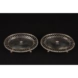 A small pair of Victorian silver oval card waiters
hallmarked London 1843, with central engraved