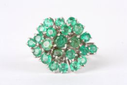 An 18ct white gold and emerald cluster ringset with 23 circular emeralds in a plain 18ct yellow