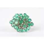 An 18ct white gold and emerald cluster ring
set with 23 circular emeralds in a plain 18ct yellow
