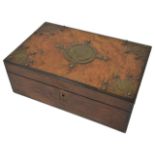 A Victorian figured walnut writing box with brass mounts and opening to reveal a fitted interior.