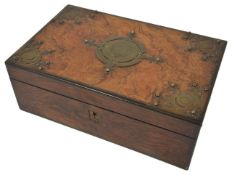 A Victorian figured walnut writing box with brass mounts and opening to reveal a fitted interior.