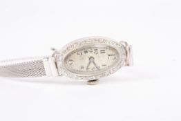 An Art Deco diamond set Rolex cocktail watch, the oval dial, unmarked and having Arabic numerals