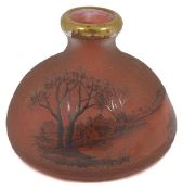 A small Daum acid etched red glass bottle vase finely decorated with a trees beside a lake. Signed