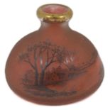 A small Daum acid etched red glass bottle vase finely decorated with a trees beside a lake. Signed