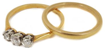 An delicate three stone diamond set ring in 18ct gold mount and a 22ct gold wedding band (2) Size