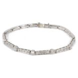 An Art Deco diamond set articulated line bracelet, formed as five collet mounted brilliant cut