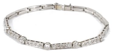 An Art Deco diamond set articulated line bracelet, formed as five collet mounted brilliant cut