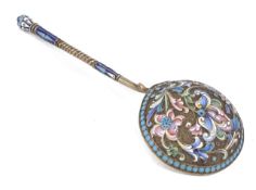 A Russian silver gilt and enamel ladle decorated with a stylised floral scrolling design in shaded