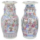 Two large early 20th century Chinese Canton enamel vases with dogs of foe handles, both painted with