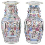 Two large early 20th century Chinese Canton enamel vases with dogs of foe handles, both painted with