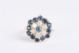 An 18ct white, sapphire and diamond cluster ring set with central sapphire surrounded by six