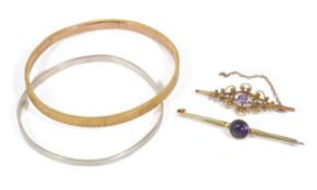 A Victorian 9ct gold and seed pearl scroll brooch, a 15ct gold amethyst set bar brooch, a 9ct gold