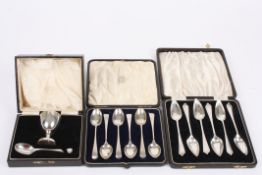 A cased set of silver teaspoons and a set of silver grapefruit spoons together with a cased