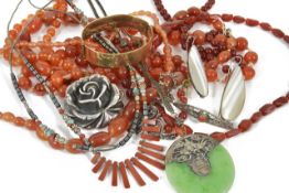 A collection of carnelian bead necklaces, a Native American Indian polished hardstone fringe