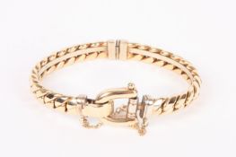 A Continental yellow metal 'horse bit' bangle, the hinged bangle of curb link chain design,