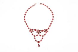 A Georgian flat cut garnet floral garland drop necklace, the chain linked garnets foil backed and