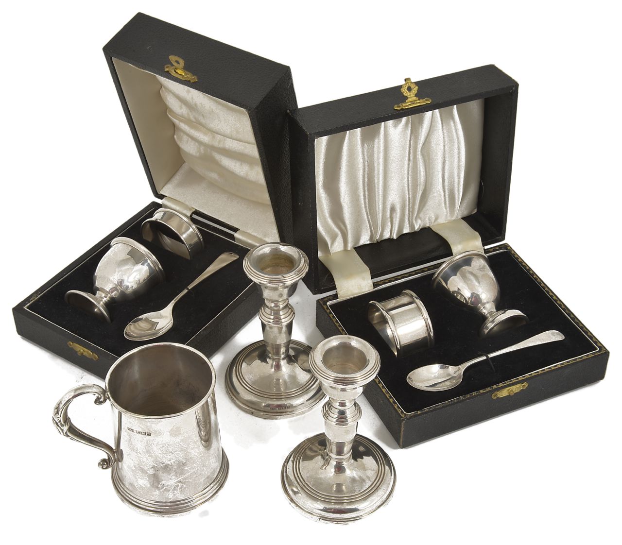 Two silver cased Christening egg cup, spoon and napkin ring sets together with a pair of miniature