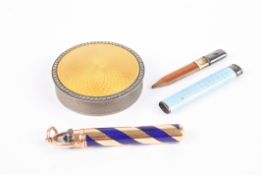 An early 20th century gold and enamel cased pencil with cabochon stone top, together with a silver